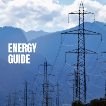 Power transmission lines against a mountain backdrop with the text "Energy Guide," representing the energy sector and infrastructure.